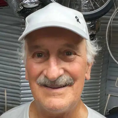 A man with a white hat and mustache.