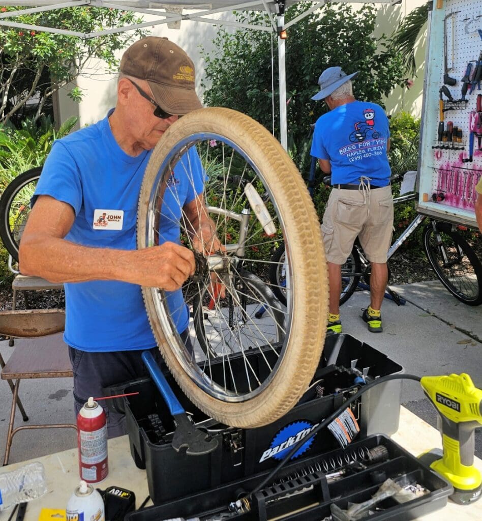 A man working on a bicycle tire.
